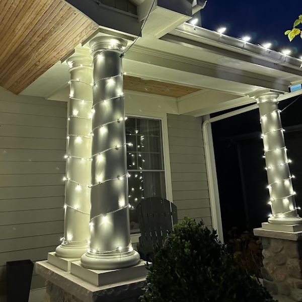 Wraparound LED lighting on a home’s eaves and columns, symmetrical layout