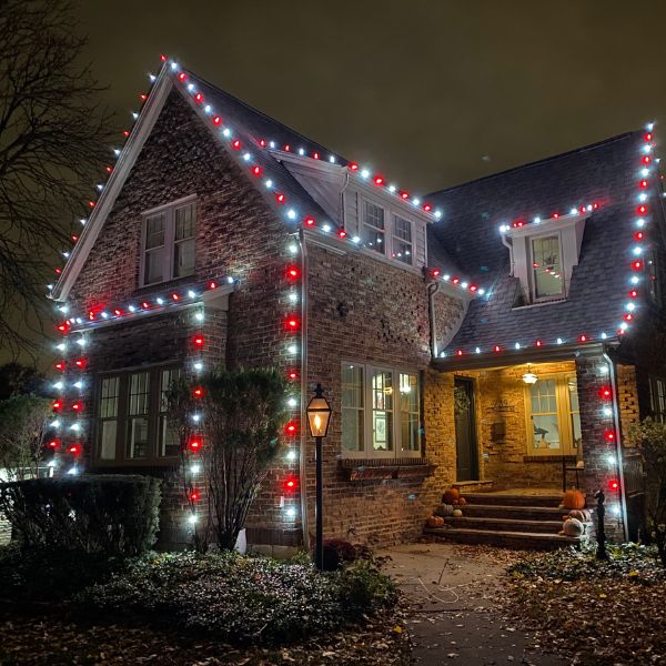 Side view of house with LED strings along roof and windows